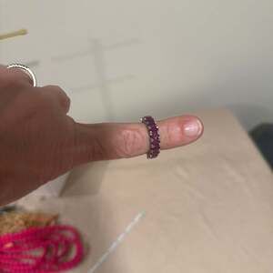 Red Emerald Cut Cubic Zirconia Eternity Band in Rhodium Plated Sterling Silver